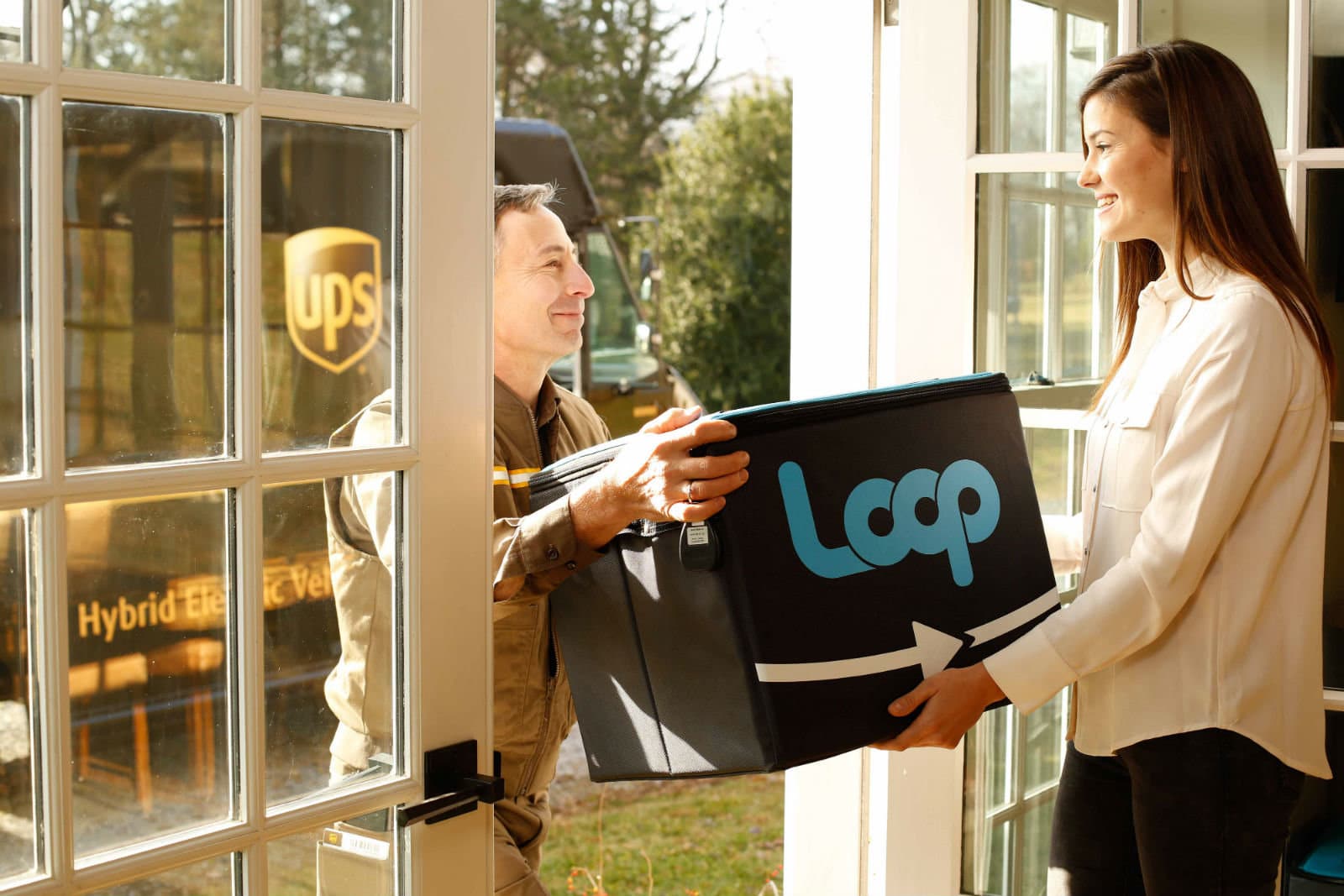 UPS Driver delivers reusable packaging to woman at home